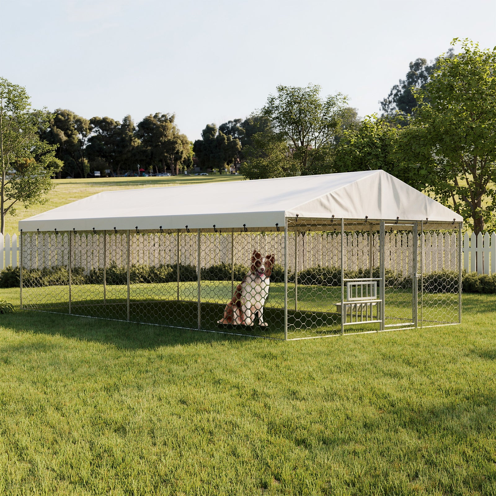Large outdoor dog kennel with white canopy, galvanized steel frame, chain-link fencing, and a dog sitting inside on green grass in a fenced yard.