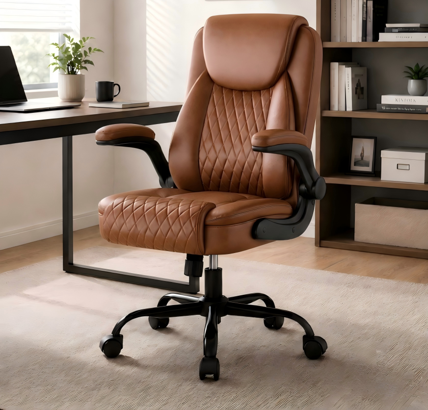Brown ergonomic office chair with quilted leather upholstery and adjustable flip-up arms, positioned in a modern home office with desk, plants, and shelves in the background.