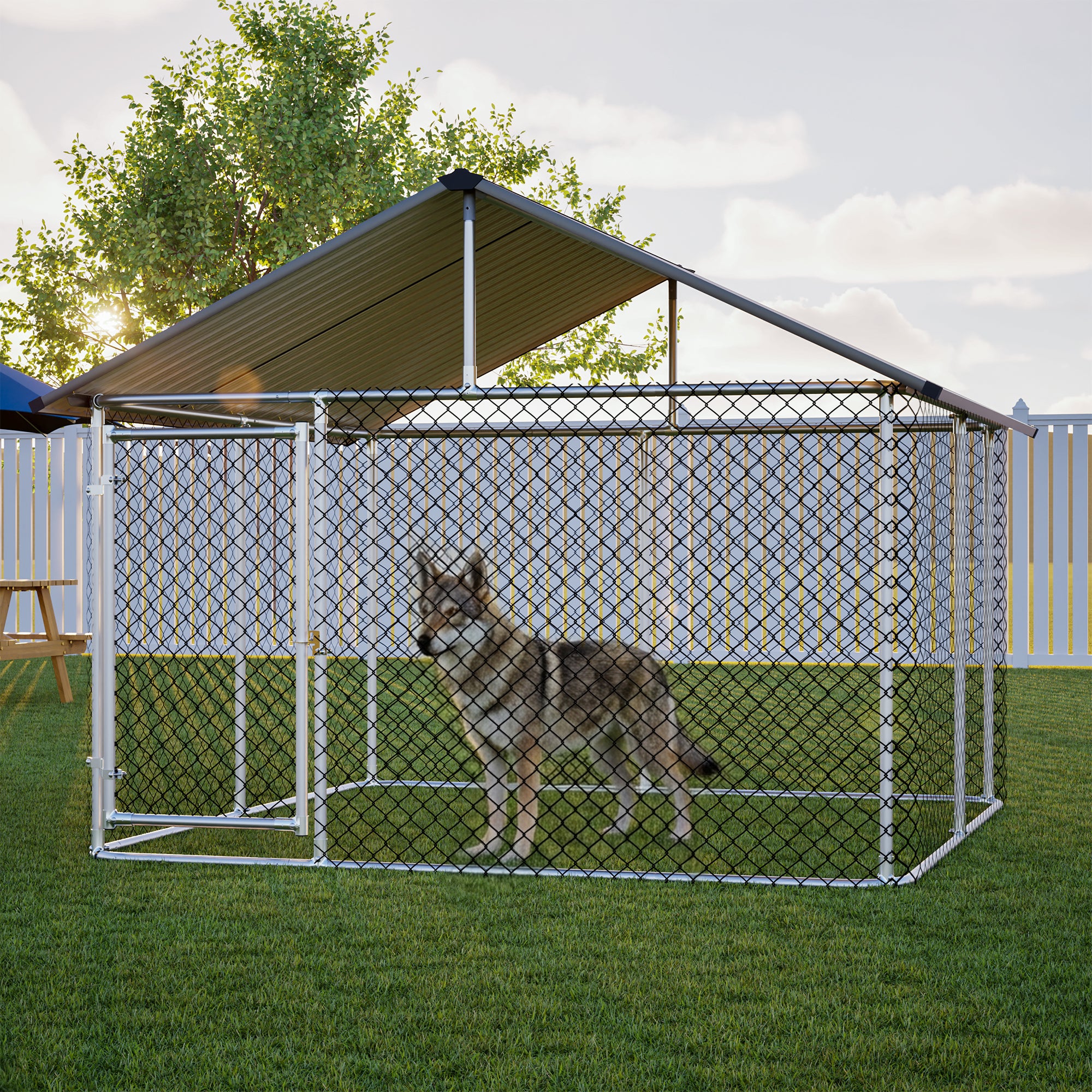 Large metal outdoor dog kennel with rust-proof wire mesh and a sturdy roof, securely enclosing a dog on green grass in a backyard setting at sunset.