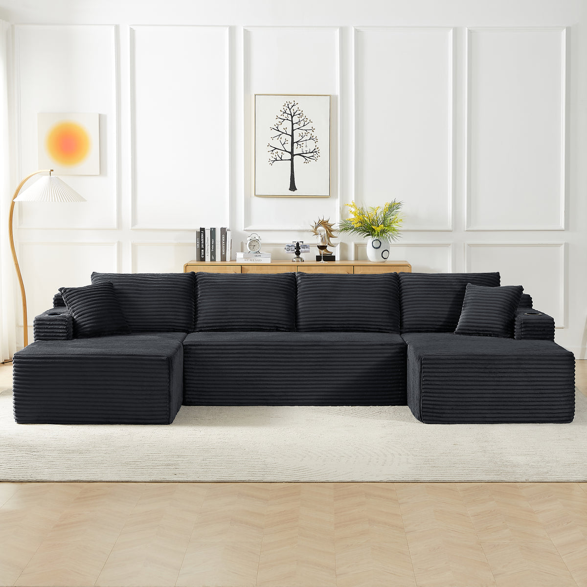 Dark grey compressible U-shaped sectional sofa with corduroy fabric in a minimalist living room setting, featuring wall art, wooden cabinet, and a floor lamp.