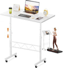 White adjustable standing desk with laptop, keyboard, and other items on a white background