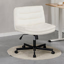 White armless adjustable office chair with padded seat and backrest on black caster base, placed on a round beige rug next to a wooden desk in a modern home office setting.