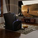 Black recliner chair with blue LED accents positioned in a living room facing a large screen showing a person walking a dog, surrounded by musical notes indicating built-in Bluetooth speakers in the recliner, placed on a patterned rug near a wooden media console, part of office furniture and recliner chairs collections.