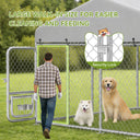 Man walking into large outdoor dog kennel with two dogs inside, highlighting walk-in size for easier cleaning and feeding and a security lock on the gate, set in a garden and outdoor environment.