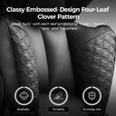 Black quilted seat covers with embossed four-leaf clover pattern on a dark background