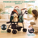 A small white dog sits inside a pet stroller with a woman kneeling beside it in a bright living room. The stroller has a green and white checkered canopy, brown leather-look trim, black frame, and mesh side panels.