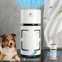 A white cylindrical pet air purifier with blue airflow graphics, shown beside a brown and white dog and a small accessory container. The scene includes a textured gray wall, a white curtain, and airflow arrows, with the brand name 'petsairpurifier' visible on the device and in the lower text.